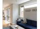 Comfortable living area features hardwood floors, a plush blue sofa, and sliding glass doors to the exterior at 3720 Jason St, Denver, CO 80211