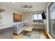 Cozy living room featuring a gray sofa, modern ceiling fan, and a built-in desk nook with a view at 3720 Jason St, Denver, CO 80211
