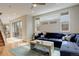 Spacious living room with hardwood floors, a comfortable blue sectional, and a seamless indoor-outdoor flow at 3720 Jason St, Denver, CO 80211