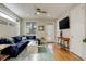 Inviting living room features hardwood floors, a comfortable blue sectional, and abundant natural light at 3720 Jason St, Denver, CO 80211