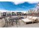 Rooftop deck with a lounge chair, table, seating, and string lights; great for entertaining at 3720 Jason St, Denver, CO 80211