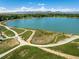 Aerial view of Waneka Lake showcasing walking paths, lush greenery and a tranquil lake at 1996 Clipper Dr, Lafayette, CO 80026