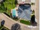 Aerial view of house showcasing a backyard pool, solar panels, and landscaped yard at 1996 Clipper Dr, Lafayette, CO 80026