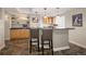 Basement bar area featuring a counter with seating, cabinetry, and stylish lighting for entertaining guests at 1996 Clipper Dr, Lafayette, CO 80026