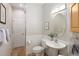Well-lit bathroom with classic fixtures, a pedestal sink, and wainscoting for a clean design at 1996 Clipper Dr, Lafayette, CO 80026