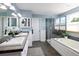 Bathroom featuring double sinks, a soaking tub, and walk-in shower at 1996 Clipper Dr, Lafayette, CO 80026