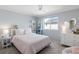 Charming bedroom with soft pink accents, a comfortable bed, and plenty of natural light from the window at 1996 Clipper Dr, Lafayette, CO 80026