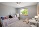 Bright bedroom featuring playful decor, comfortable bed, large window, and neutral colors for a cozy feel at 1996 Clipper Dr, Lafayette, CO 80026
