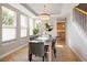 Elegant dining room featuring tray ceilings, modern lighting, and views of the yard through large windows at 1996 Clipper Dr, Lafayette, CO 80026