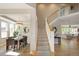 Open foyer with staircase leading to the upper level and views of the dining and living areas at 1996 Clipper Dr, Lafayette, CO 80026