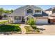 Charming two-story home featuring a stone facade, covered porch, and well-manicured lawn at 1996 Clipper Dr, Lafayette, CO 80026