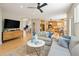 Open-concept living room with hardwood floors and seamless flow to kitchen and dining spaces at 1996 Clipper Dr, Lafayette, CO 80026