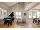 Comfortable living space includes a grand piano, sitting area, and dining, all in a bright open setting at 1996 Clipper Dr, Lafayette, CO 80026