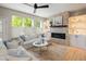 Cozy living room featuring a stone fireplace, built-in shelves, and ample natural light at 1996 Clipper Dr, Lafayette, CO 80026