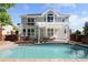 A beautiful backyard swimming pool and patio area with pergola and seating at 1996 Clipper Dr, Lafayette, CO 80026