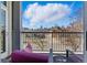 A view of the city from the balcony with wrought iron railing and comfortable patio seating at 1738 N Franklin St # 2B, Denver, CO 80218