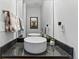 Modern powder room features a vessel sink, granite countertop, and stylish fixtures at 1738 N Franklin St # 2B, Denver, CO 80218