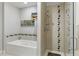 Bathroom featuring both a shower stall with glass door and a soaking tub at 1738 N Franklin St # 2B, Denver, CO 80218