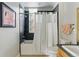 A bathroom with a tiled shower/tub combo and a toilet next to a vanity at 1738 N Franklin St # 2B, Denver, CO 80218