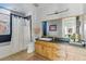 Bright bathroom featuring a wood vanity, a soaking tub, and a modern design at 1738 N Franklin St # 2B, Denver, CO 80218