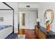 Bedroom view featuring hardwood floors, modern design, and bathroom access at 1738 N Franklin St # 2B, Denver, CO 80218