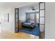 Stylish bedroom featuring an accent wall, custom glass doors, and ample natural light at 1738 N Franklin St # 2B, Denver, CO 80218