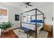 Stylish bedroom with canopy bed, wood floors, and bright natural light at 1738 N Franklin St # 2B, Denver, CO 80218