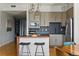 Eat-in kitchen features bar seating, stainless appliances, and pendant lighting at 1738 N Franklin St # 2B, Denver, CO 80218