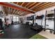 Finished basement area with a home gym setup featuring workout equipment, weights, and rubber flooring at 10580 Greycliffe Dr, Highlands Ranch, CO 80126