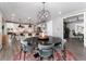Dining area with a modern light fixture, seating for six, and an open concept to the kitchen at 10580 Greycliffe Dr, Highlands Ranch, CO 80126