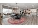 Bright dining area with large windows, a modern chandelier, and seamless access to the outdoor patio and kitchen at 10580 Greycliffe Dr, Highlands Ranch, CO 80126