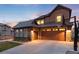 Attached three-car garage featuring paneled doors and a basketball hoop, promising both convenience and recreational fun at 10580 Greycliffe Dr, Highlands Ranch, CO 80126