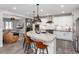 Spacious open-concept kitchen flowing into the living area, showcasing a large island, stainless appliances, and a cozy fireplace at 10580 Greycliffe Dr, Highlands Ranch, CO 80126