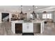 Open-concept kitchen with large island, wine fridge, stainless steel appliances, seamlessly connecting to dining and living spaces at 10580 Greycliffe Dr, Highlands Ranch, CO 80126
