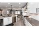 Contemporary kitchen with stainless steel appliances, ample counter space, and open layout offering seamless flow to the living area at 10580 Greycliffe Dr, Highlands Ranch, CO 80126