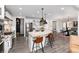 Open kitchen with island, breakfast bar seating, pendant lighting, and stainless steel appliances at 10580 Greycliffe Dr, Highlands Ranch, CO 80126