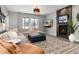 Comfortable living room features a large sectional sofa, fireplace, and a view of the outdoors at 10580 Greycliffe Dr, Highlands Ranch, CO 80126