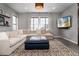 Comfortable living room featuring a sectional sofa, mounted TV, and bright natural light at 10580 Greycliffe Dr, Highlands Ranch, CO 80126