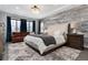 Luxurious main bedroom features a wood accent wall, plush carpet, and comfortable seating area at 10580 Greycliffe Dr, Highlands Ranch, CO 80126