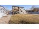 Large backyard with a pergola covered patio, providing an ideal space for outdoor activities at 12017 Triple Crown Dr, Parker, CO 80134