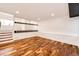 Finished basement area featuring wood floors and white wainscoting at 21743 Farmingdale Ct, Parker, CO 80138