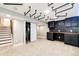 Finished basement featuring custom shelving, unique industrial lighting and easy access to utility closet at 21743 Farmingdale Ct, Parker, CO 80138