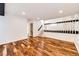 Spacious finished basement with wood floors and modern lighting at 21743 Farmingdale Ct, Parker, CO 80138