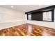 Spacious basement area with hardwood floors, white walls and decorative black accent wall at 21743 Farmingdale Ct, Parker, CO 80138