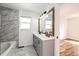 Beautiful bathroom with double sinks, a soaking tub, marble tile and modern fixtures at 21743 Farmingdale Ct, Parker, CO 80138