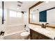 Renovated bathroom featuring subway tile, a rainfall shower head, and a wood vanity with granite countertop at 21743 Farmingdale Ct, Parker, CO 80138