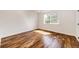 Sunlit bedroom with a large window and hardwood flooring at 21743 Farmingdale Ct, Parker, CO 80138