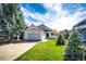 Charming two-story home with an attached two car garage and well-manicured lawn at 21743 Farmingdale Ct, Parker, CO 80138