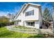 Charming white two-story home featuring a well-maintained yard with a white picket fence and lush landscaping at 21743 Farmingdale Ct, Parker, CO 80138