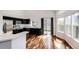 Bright kitchen with stainless steel appliances, black cabinets, white countertops and a sliding glass door at 21743 Farmingdale Ct, Parker, CO 80138